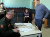 Начальник отделения призыва В.Н. Большаков изучает личное дело призывника